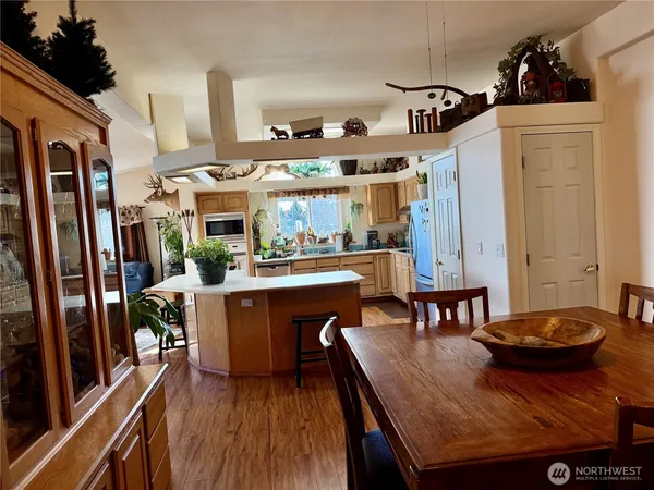 a kitchen with a table chairs and refrigerator