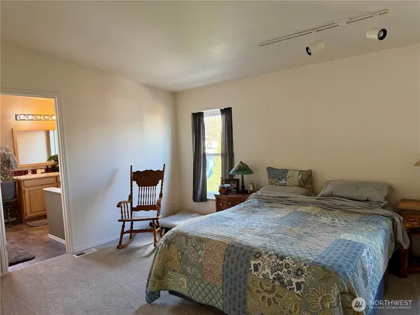 a bedroom with a bed a desk and chair