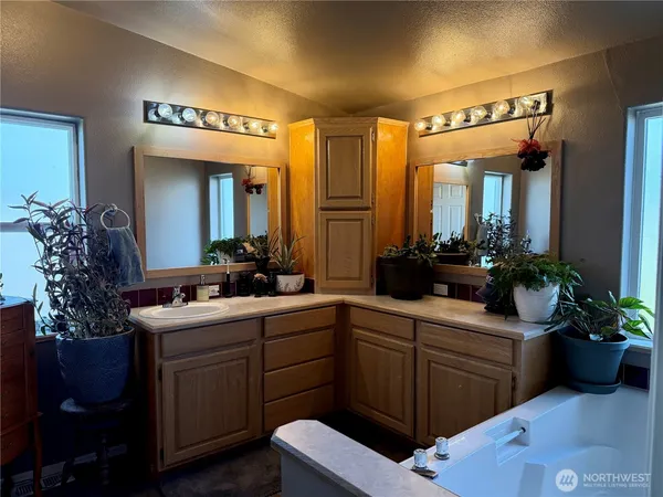 a bathroom with a double vanity sink and mirror