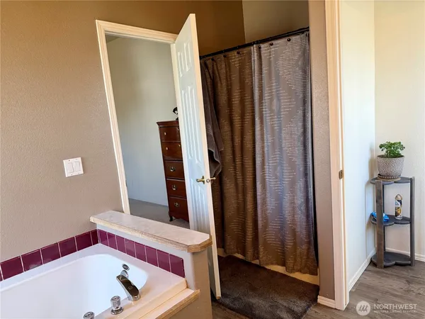 a bathroom with a bathtub and a shower