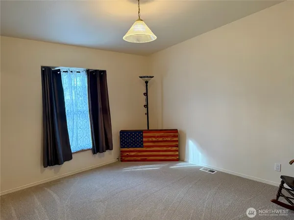 a view of room with stairs and wooden floor