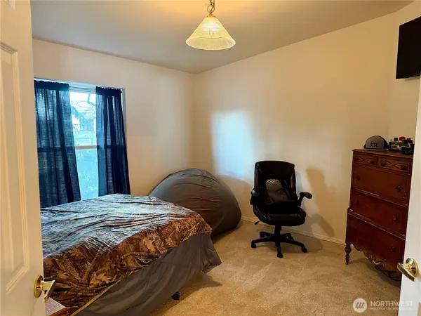 a bedroom with a bed and a chandelier