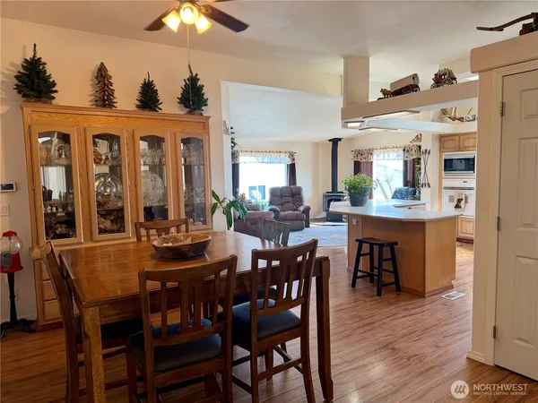 a view of a a dining room with furniture window and wooden floor