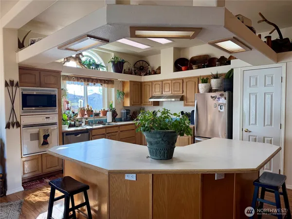 a view of a dining room with furniture and a potted plant