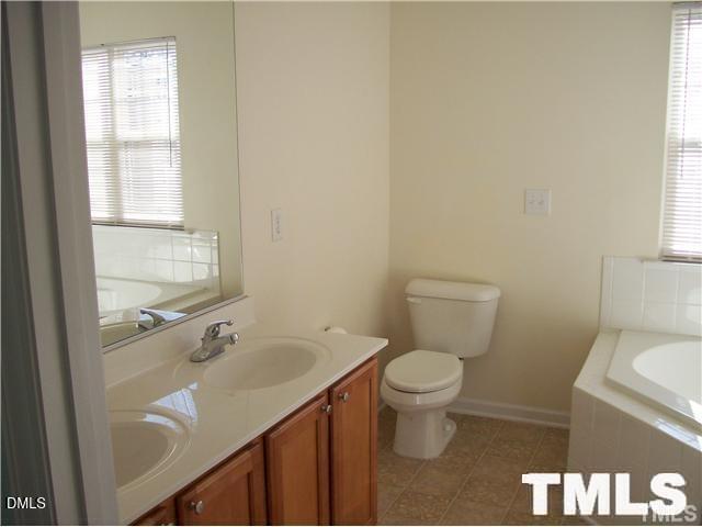 1532 Haywards Heath Lane Apex, NC 27502 - Photo 14 of 26 a bathroom with a sink and a toilet