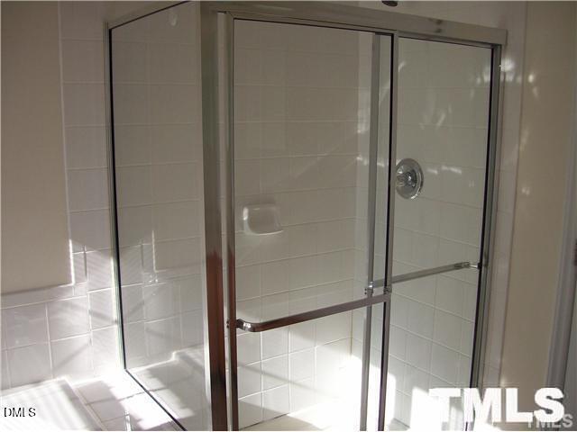 1532 Haywards Heath Lane Apex, NC 27502 - Photo 16 of 26 a bathroom with a glass shower door
