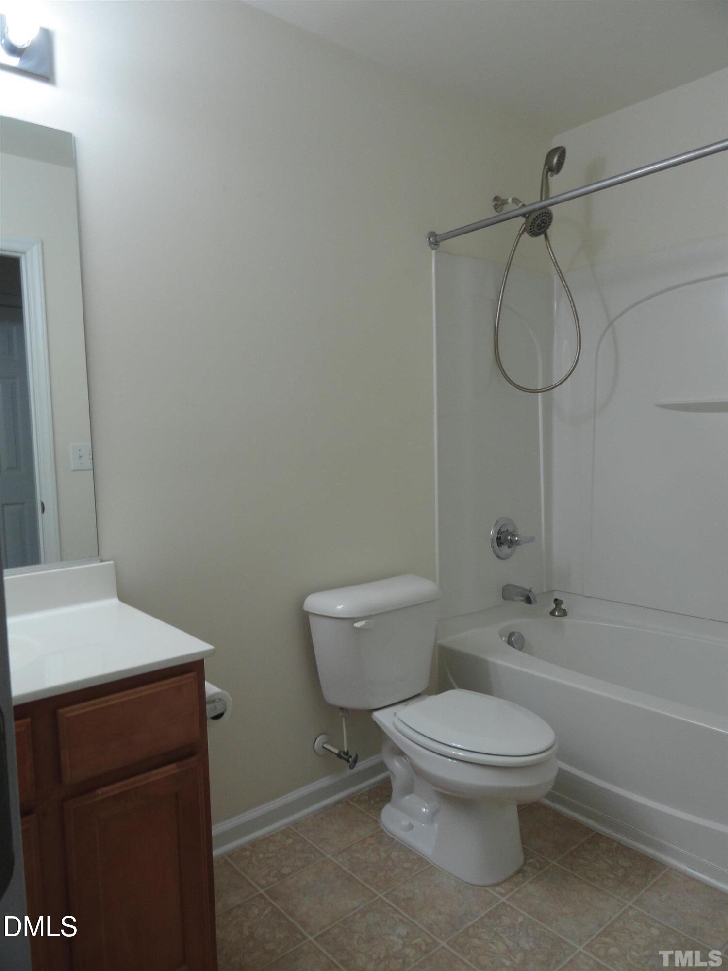 1532 Haywards Heath Lane Apex, NC 27502 - Photo 18 of 26 a white toilet sitting next to a bathroom sink