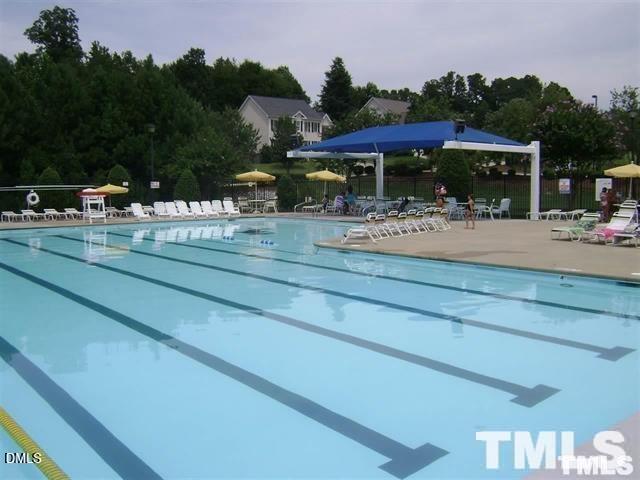 1532 Haywards Heath Lane Apex, NC 27502 - Photo 25 of 26 a view of a patio with table and chairs under an umbrella