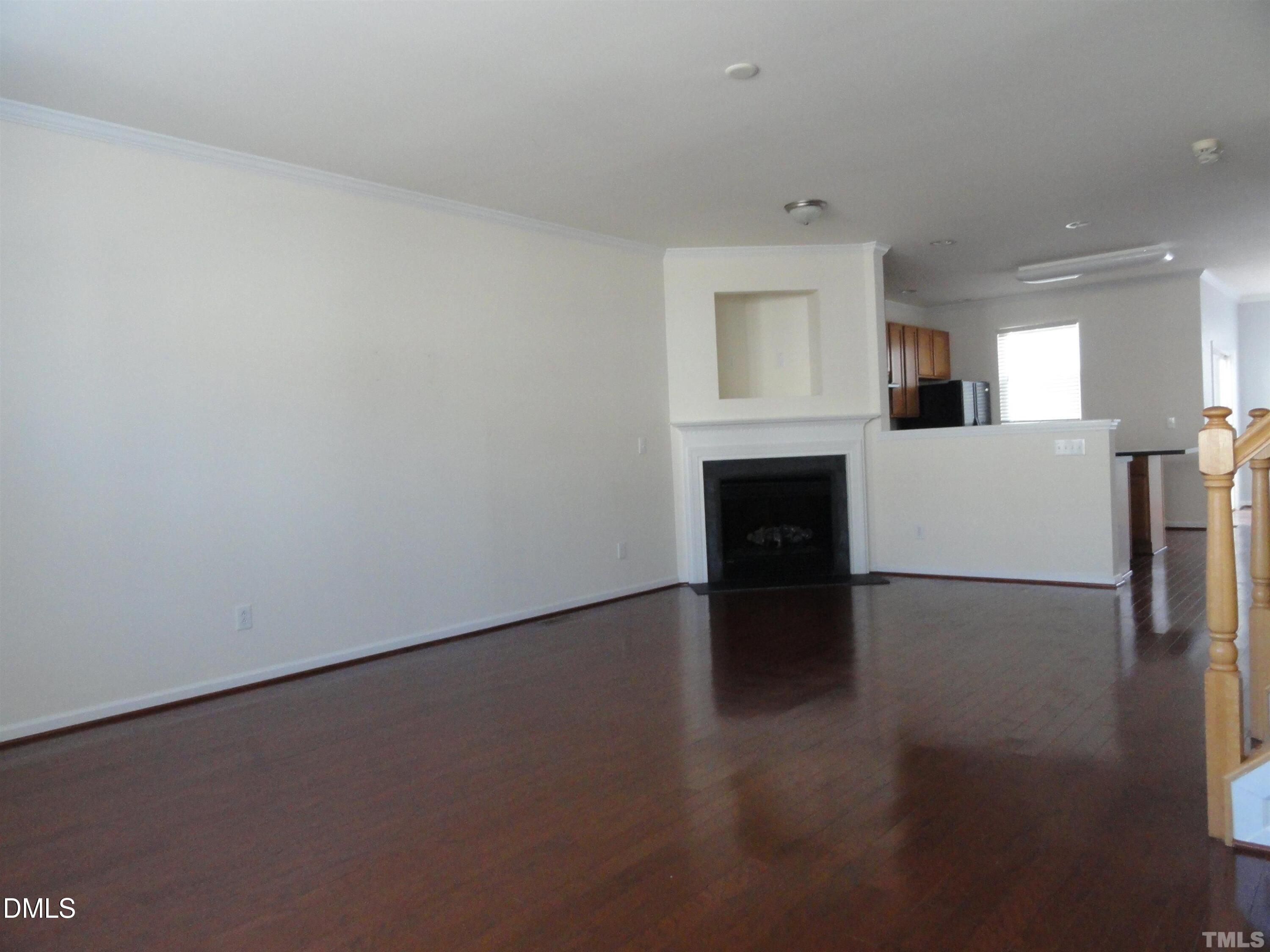 1532 Haywards Heath Lane Apex, NC 27502 - Photo 3 of 26 a view of empty room with wooden floor and fireplace