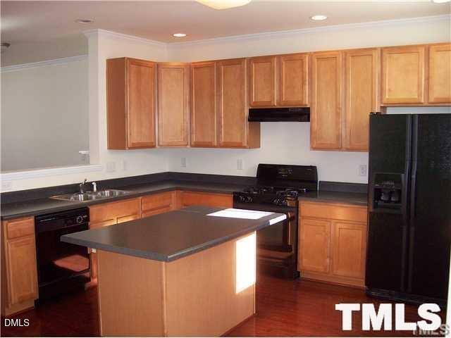 1532 Haywards Heath Lane Apex, NC 27502 - Photo 9 of 26 a kitchen with granite countertop a stove and a refrigerator