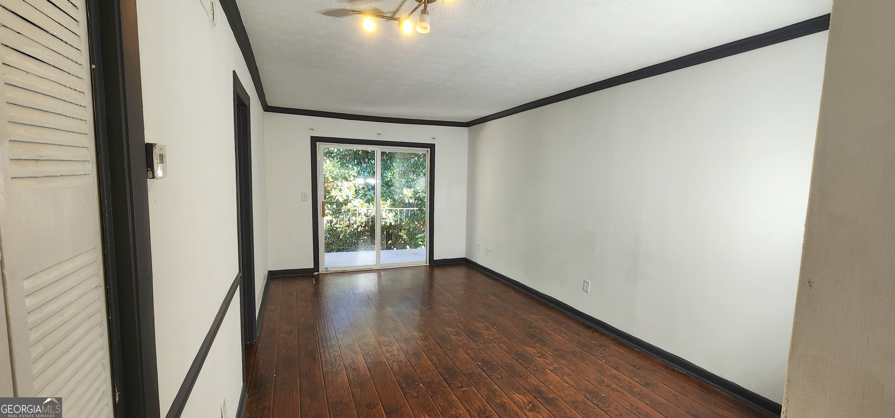 2805 Northeast Expressway Northeast, Unit B36 Atlanta, GA 30345 - Photo 4 of 30 a view of an empty room with wooden floor and a window