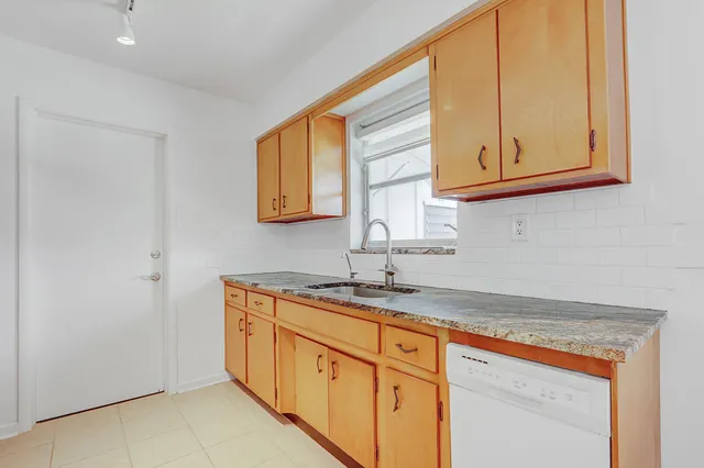 a kitchen with stainless steel appliances granite countertop a sink and a cabinets