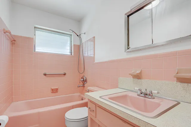 a bathroom with a sink toilet tub and shower