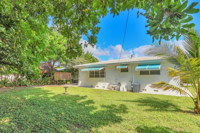 a front view of house with yard and outdoor seating