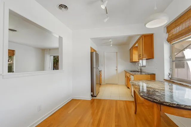 a view of a kitchen with a sink and a window