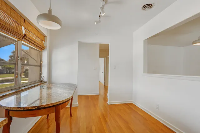 a view of a kitchen with a sink and wooden floor