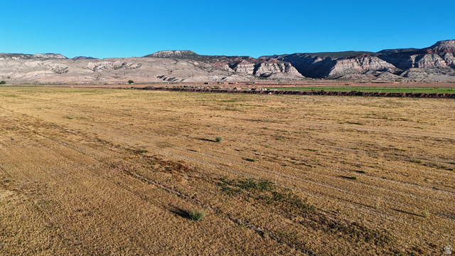 2070 East Tbd Road North Richfield, UT 84701 - Photo 24 of 35 Expansive rural landscape featuring a large field, distant mountain range, and clear sky