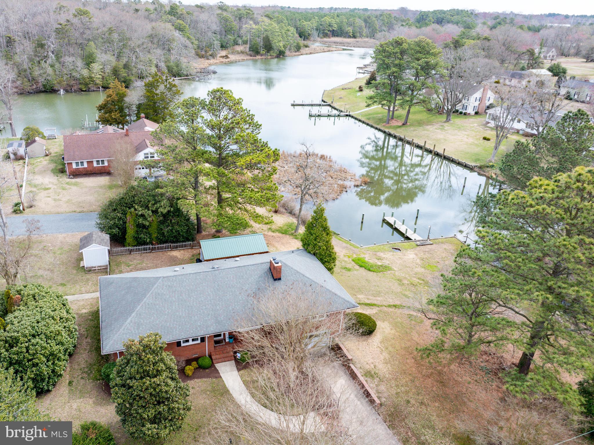 an aerial view of a house with a yard and lake view