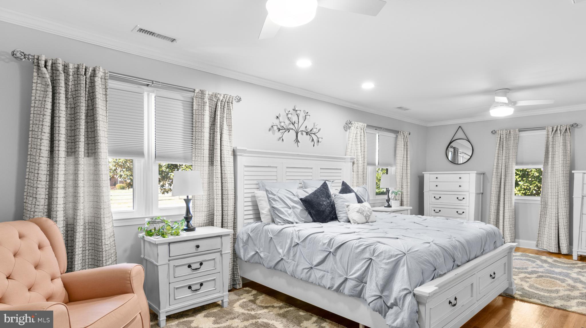 5505 Whitehall Road Cambridge, MD 21613 - Photo 18 of 44 a bedroom with a bed and wooden floor