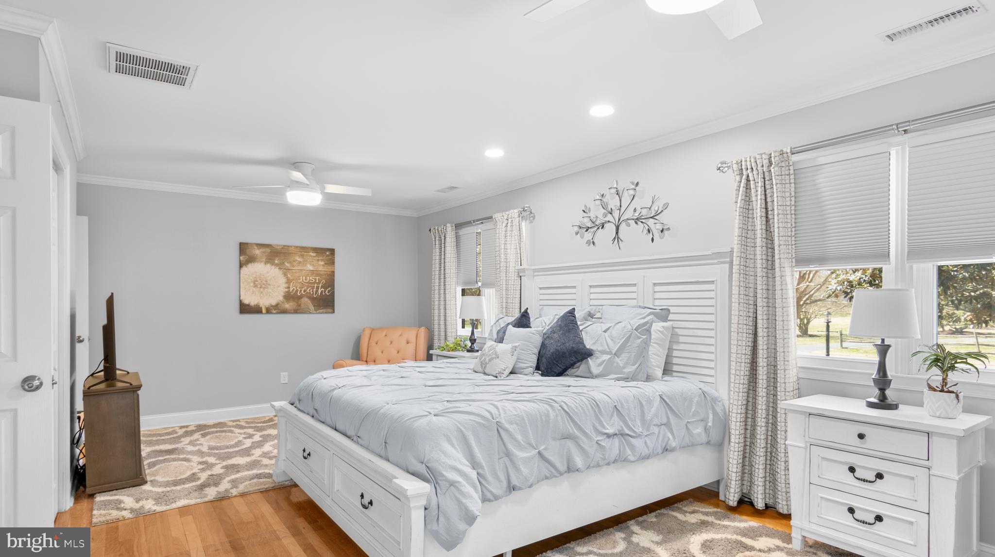 5505 Whitehall Road Cambridge, MD 21613 - Photo 20 of 44 a bedroom with a large bed and a flat tv screen on the dresser