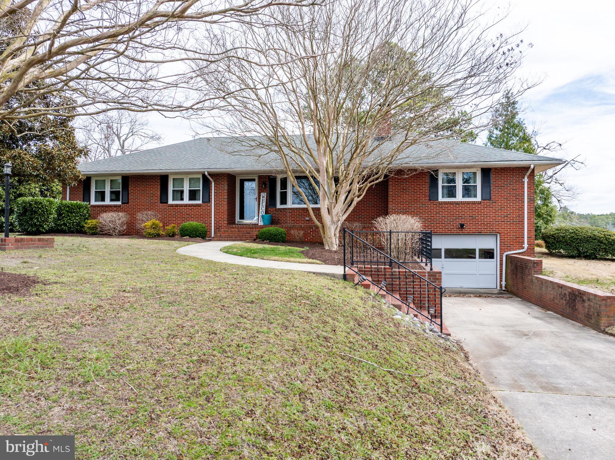 5505 Whitehall Road Cambridge, MD 21613 - Photo 2 of 44 a front view of a house with a yard and garage