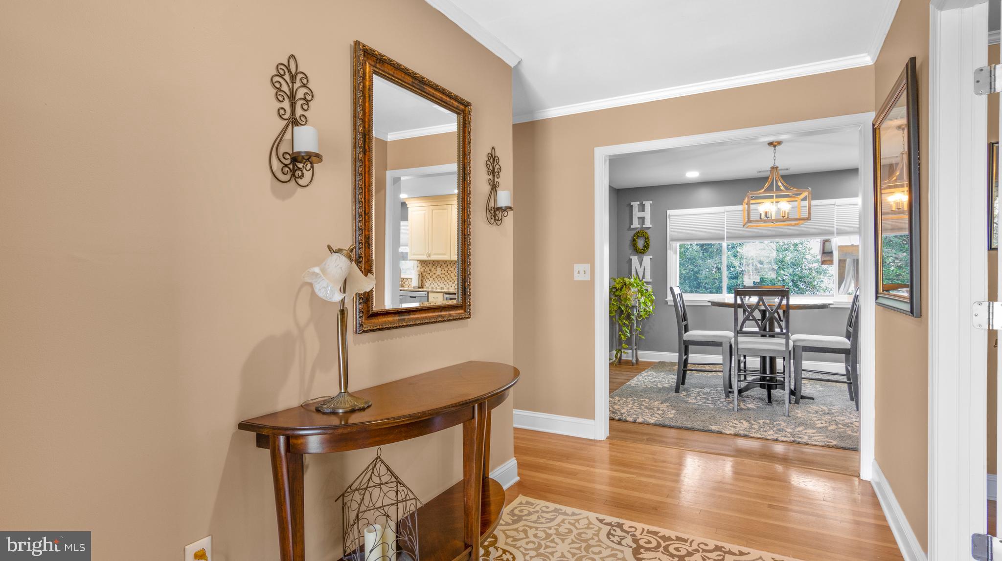 5505 Whitehall Road Cambridge, MD 21613 - Photo 4 of 44 a view of a hallway with wooden floor and a dining table