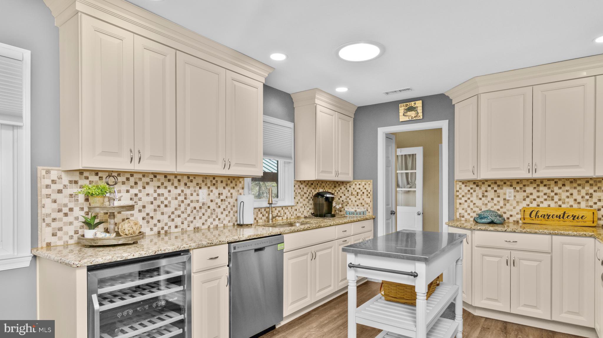 5505 Whitehall Road Cambridge, MD 21613 - Photo 8 of 44 a kitchen with stainless steel appliances granite countertop a sink stove and cabinets