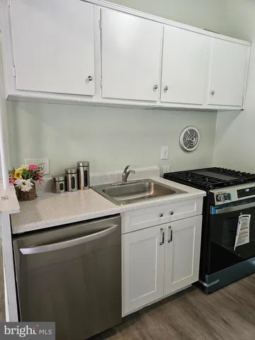a kitchen with a sink and cabinets