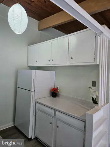 a kitchen with a refrigerator and cabinets