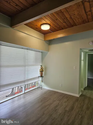 a view of a room with wooden floor