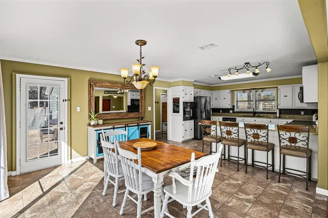 a large kitchen with a table and chairs