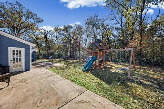 a backyard of a house with table and chairs