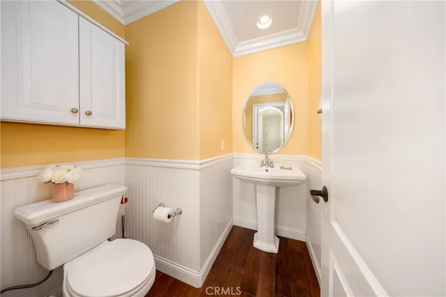 a bathroom with a sink toilet and a mirror