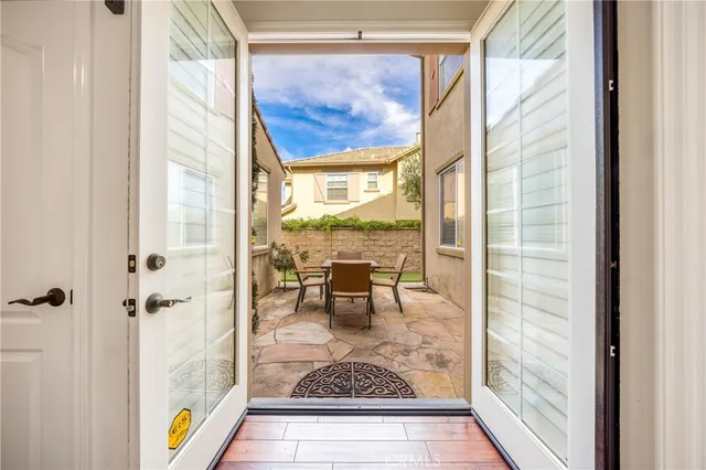 a view of living room with a fireplace and a table next to a window