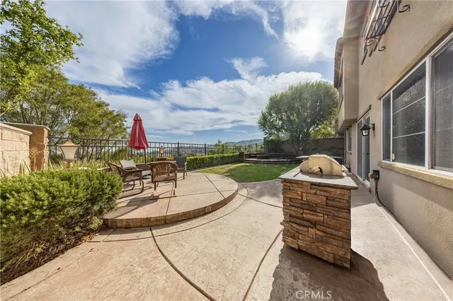 a view of a patio with couches table and chairs and potted plants