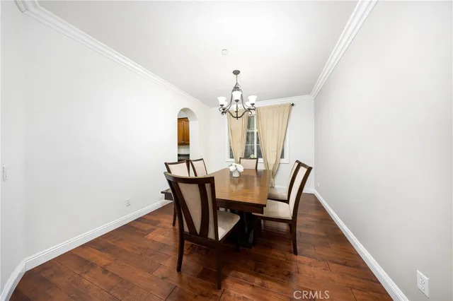a view of a dining room with furniture and chandelier