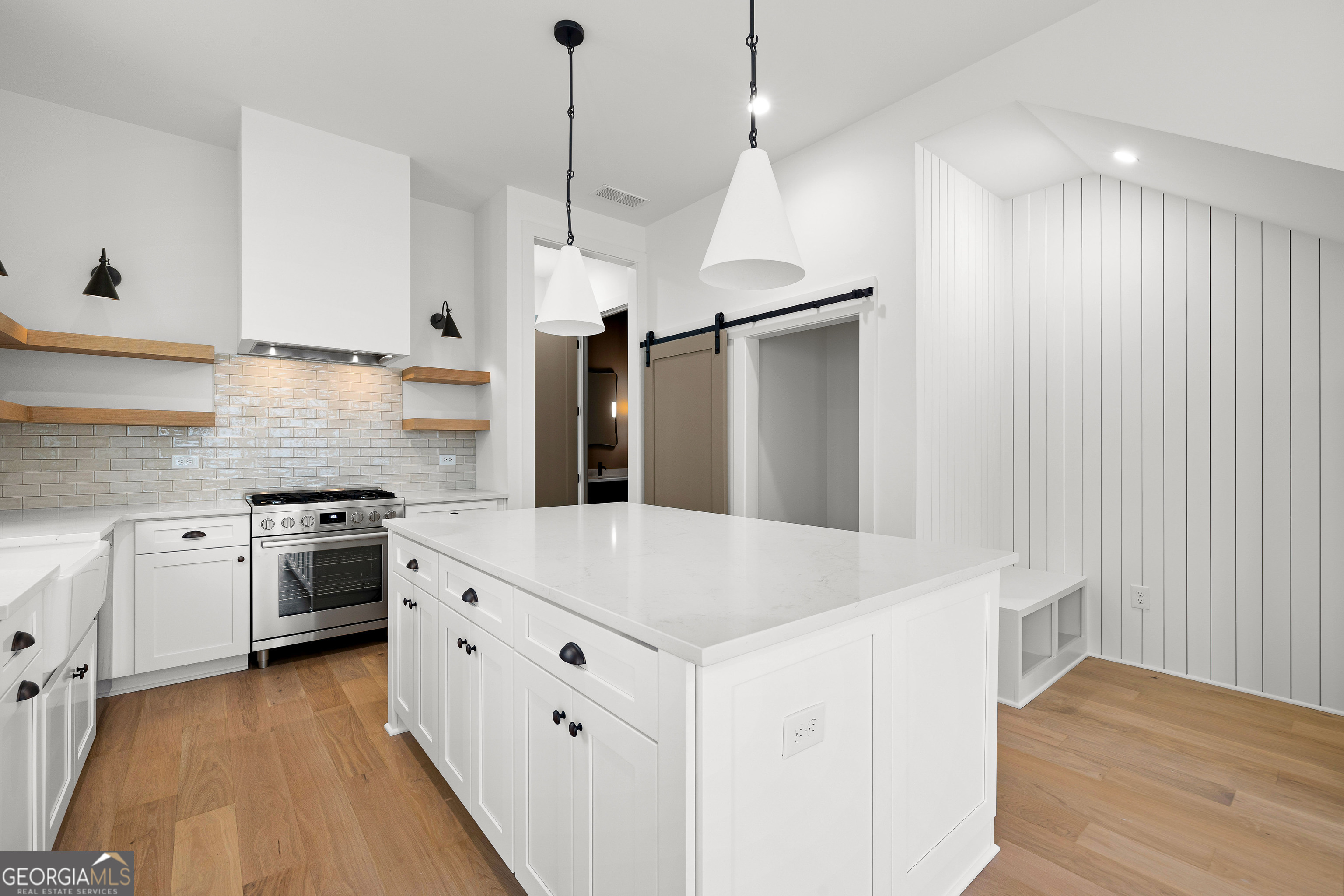 225 Rolison Way Fayetteville, GA 30214 - Photo 12 of 46 a kitchen with white cabinets and stainless steel appliances
