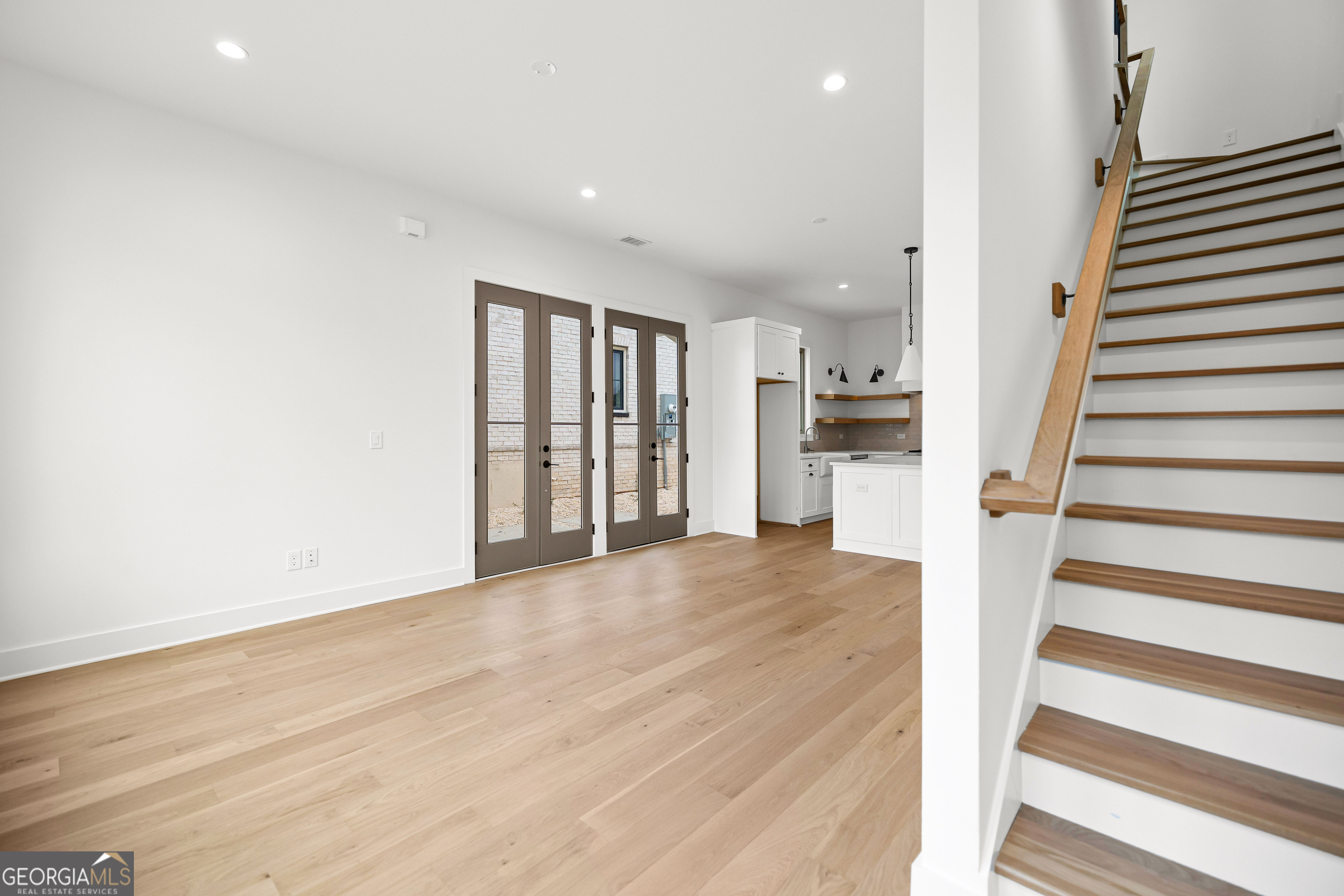 225 Rolison Way Fayetteville, GA 30214 - Photo 20 of 46 a view of a kitchen with wooden floor and stairs