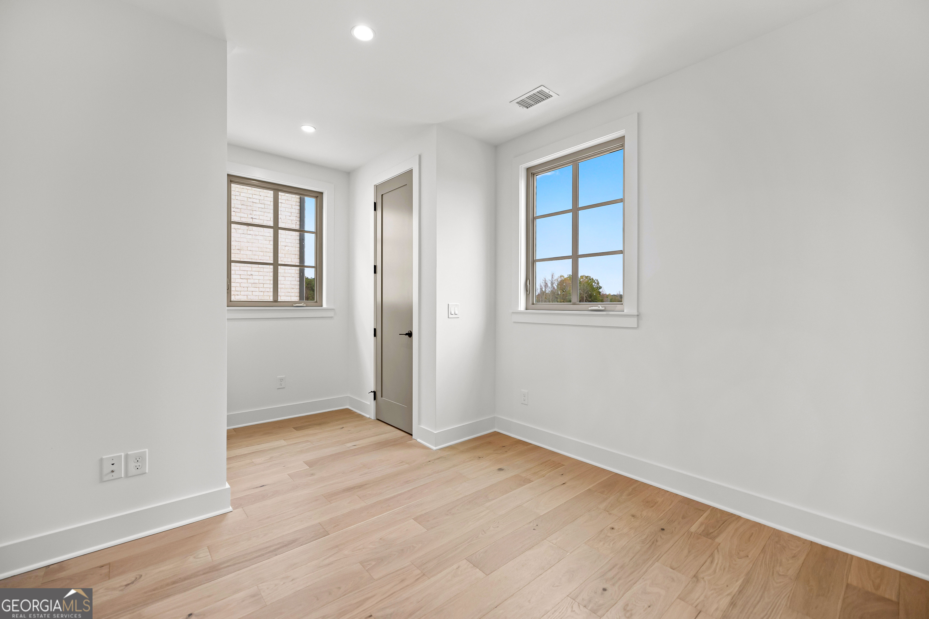 225 Rolison Way Fayetteville, GA 30214 - Photo 23 of 46 an empty room with wooden floor and windows