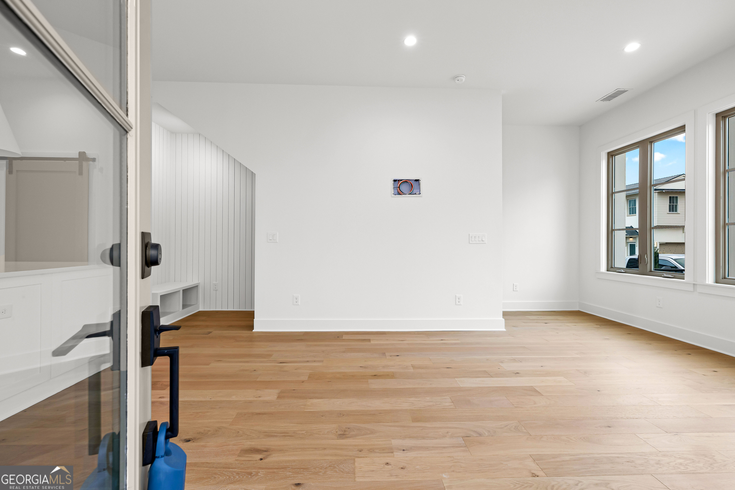 225 Rolison Way Fayetteville, GA 30214 - Photo 5 of 46 a view of an empty room with wooden floor and a window