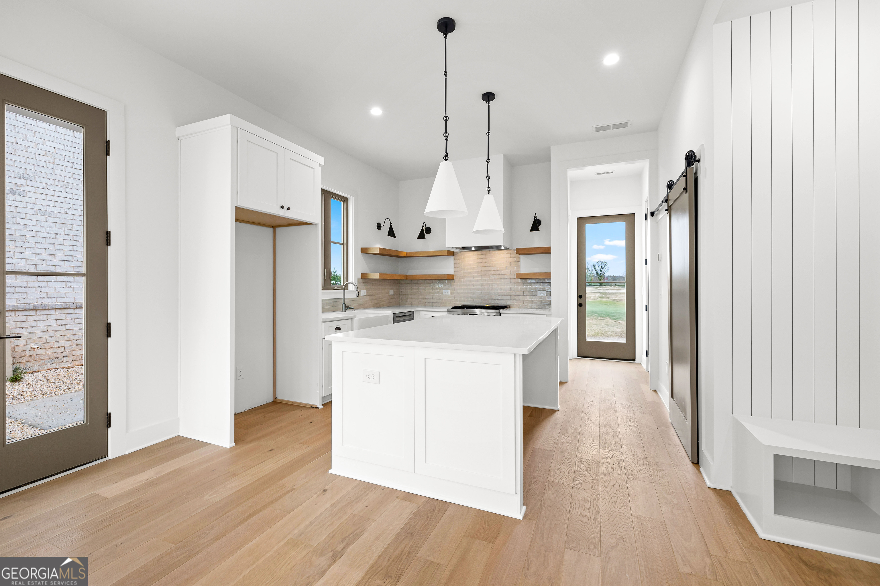 225 Rolison Way Fayetteville, GA 30214 - Photo 7 of 46 a kitchen with kitchen island white cabinets and stainless steel appliances