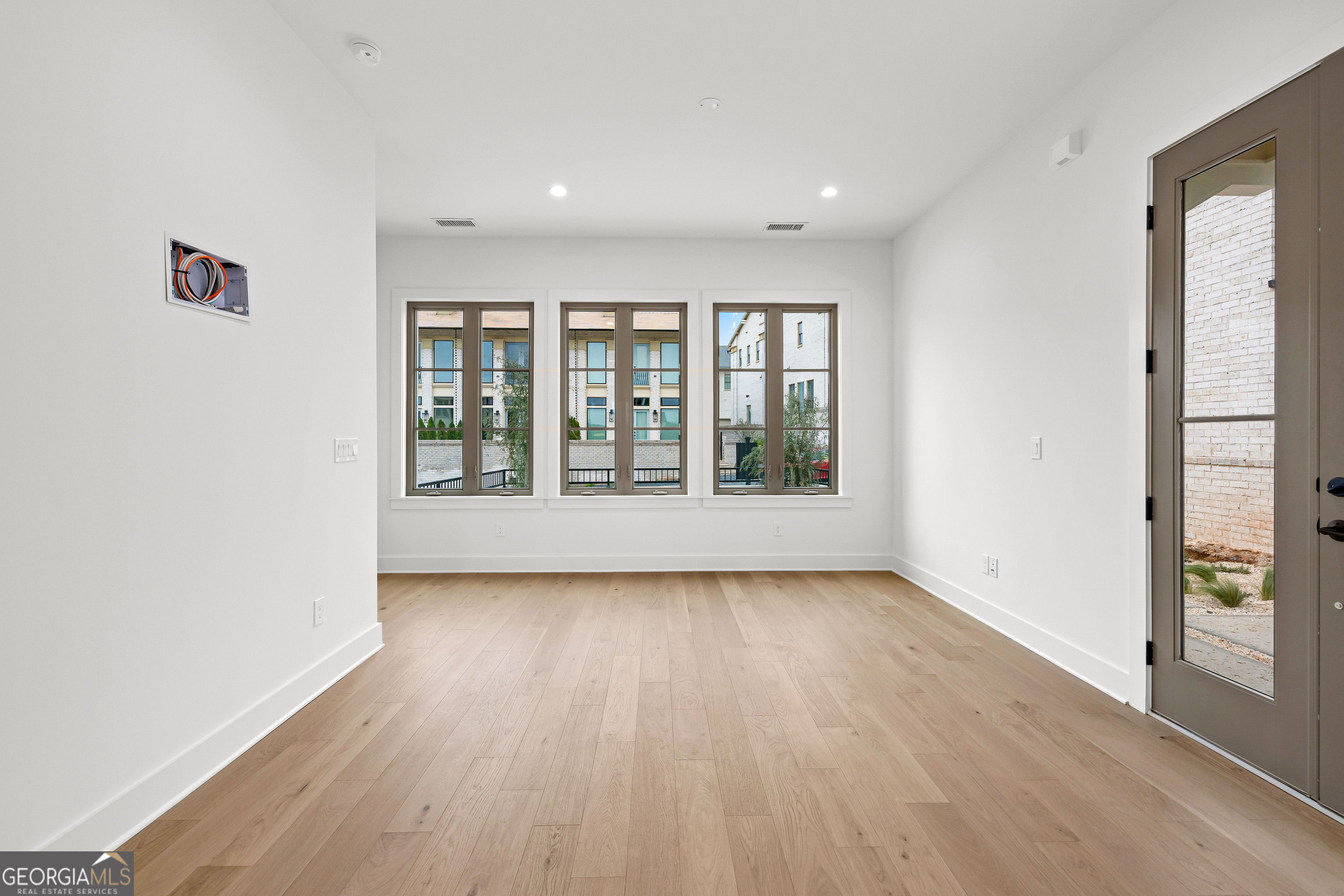 225 Rolison Way Fayetteville, GA 30214 - Photo 8 of 46 an empty room with wooden floor and windows