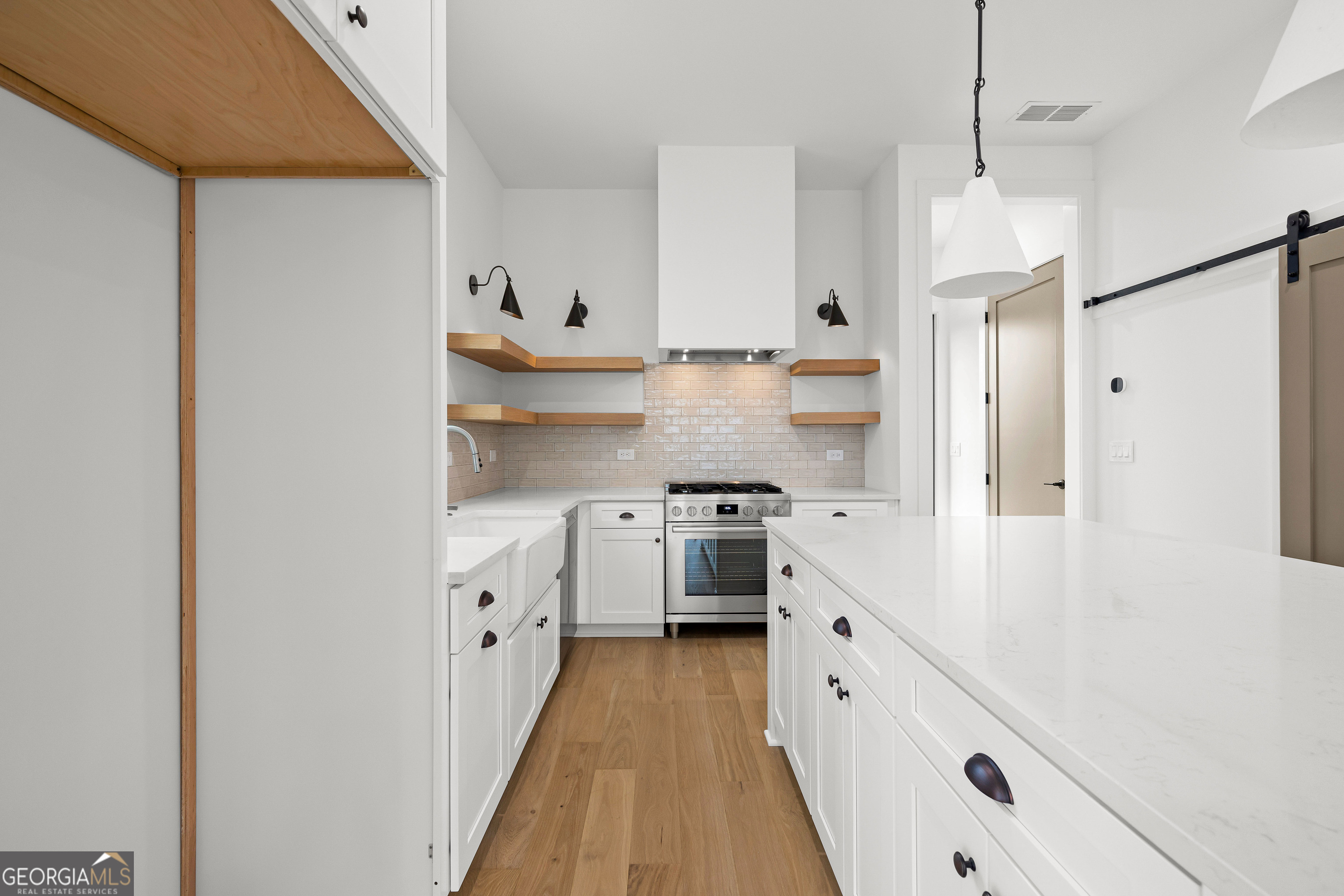225 Rolison Way Fayetteville, GA 30214 - Photo 10 of 46 a kitchen with white cabinets and white appliances