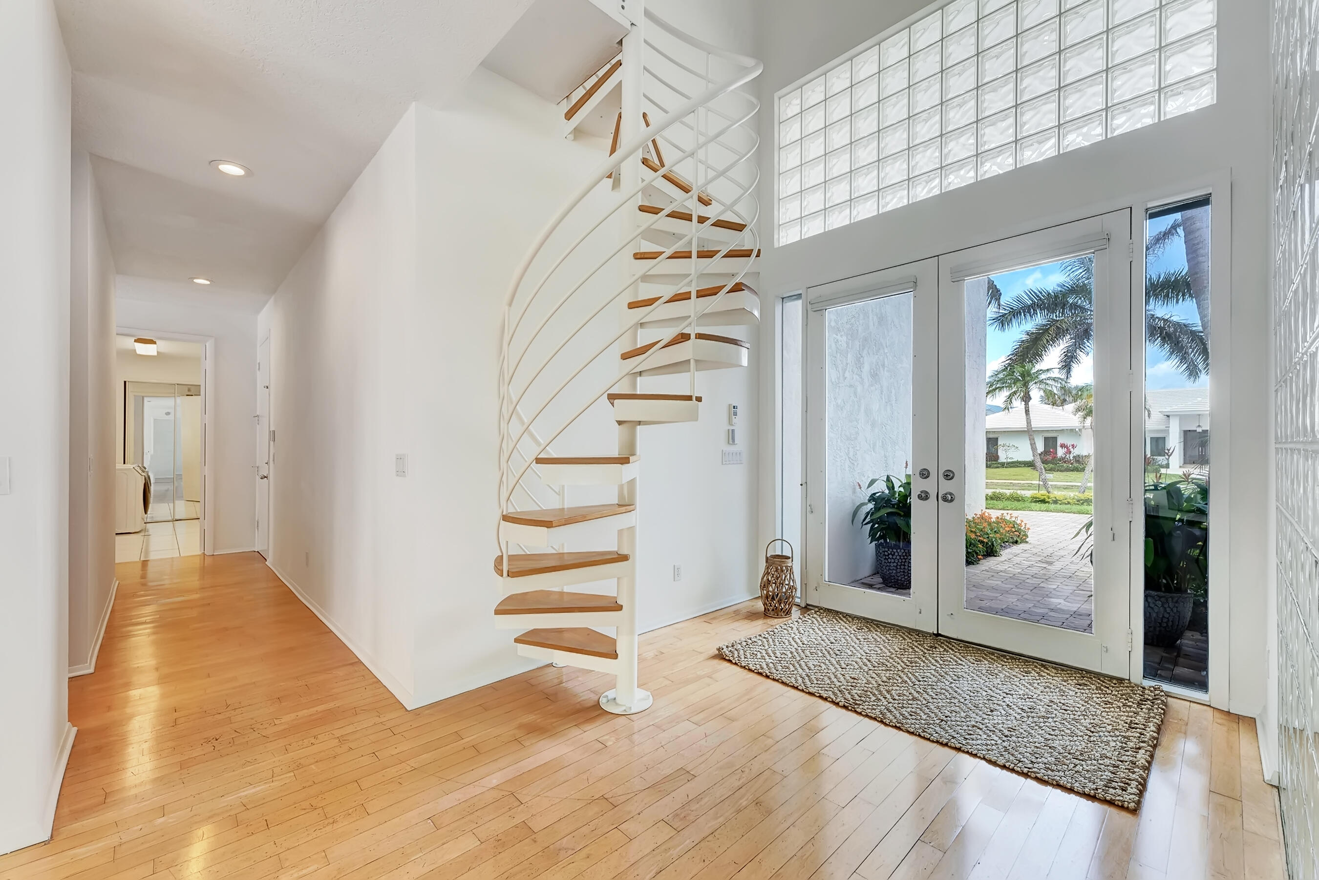 114 Olympus Circle Jupiter, FL 33477 - Photo 13 of 88 a view of a hallway view with wooden floor and windows