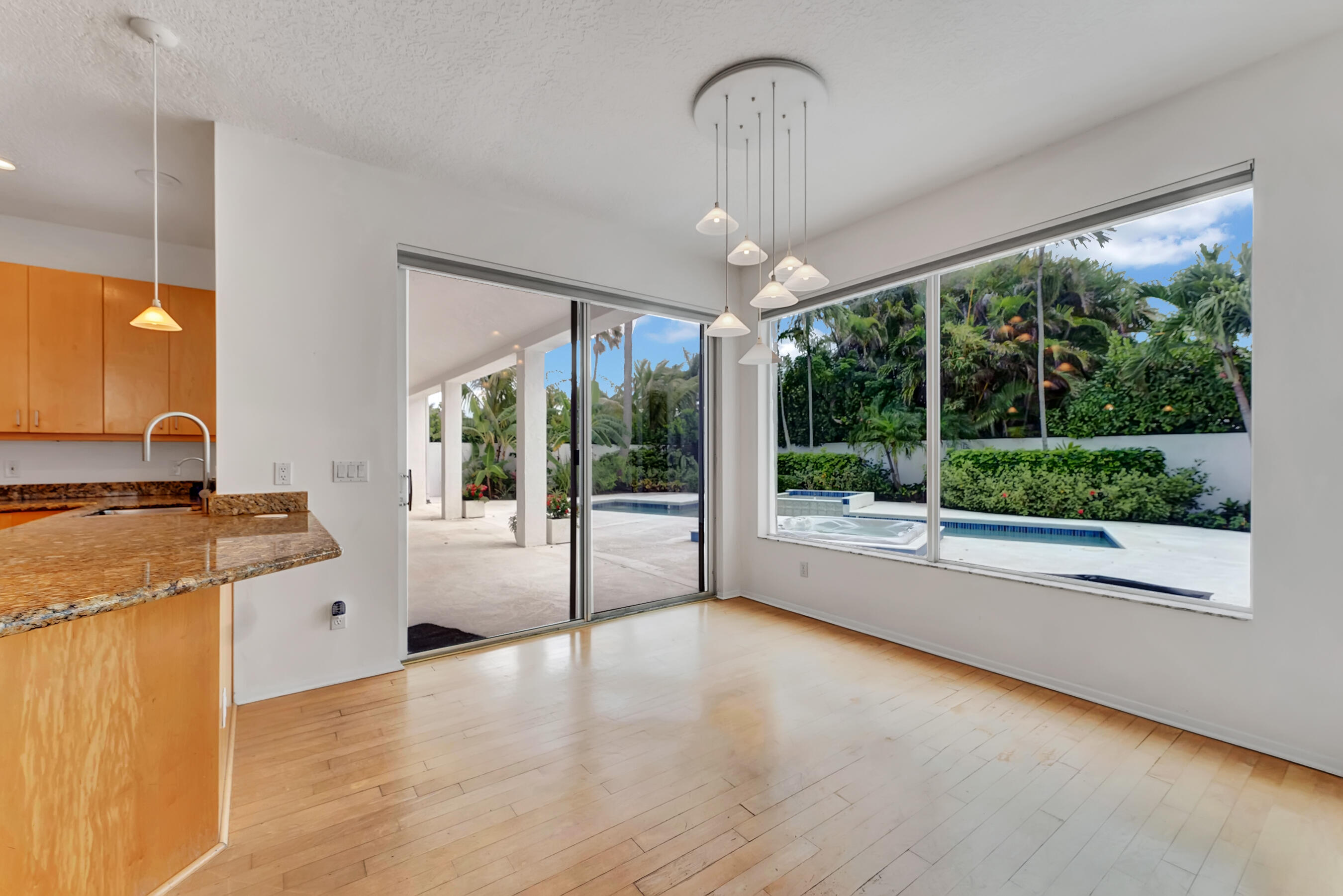 114 Olympus Circle Jupiter, FL 33477 - Photo 19 of 88 a large kitchen with stainless steel appliances granite countertop a stove and a view of living room