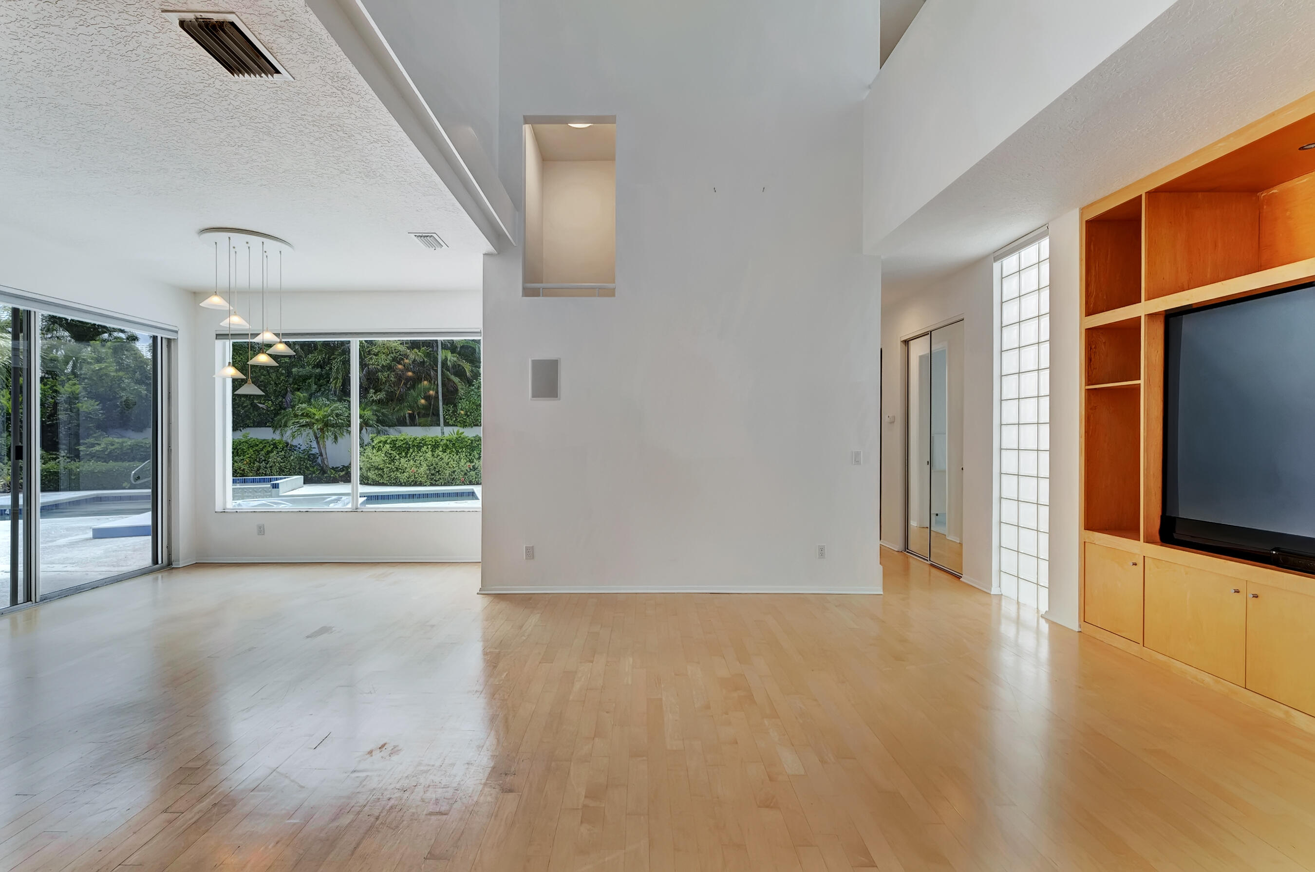 114 Olympus Circle Jupiter, FL 33477 - Photo 22 of 88 an empty room with wooden floor and windows