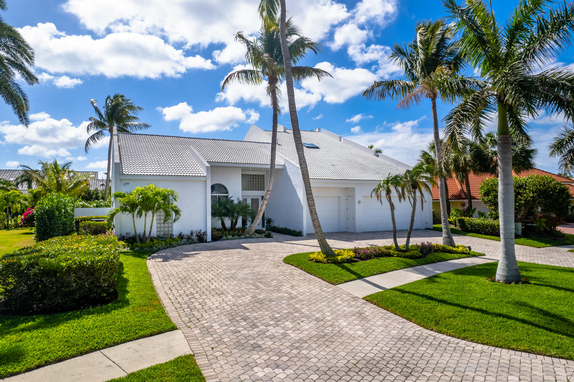 114 Olympus Circle Jupiter, FL 33477 - Photo 3 of 88 a front view of a house with garden and patio