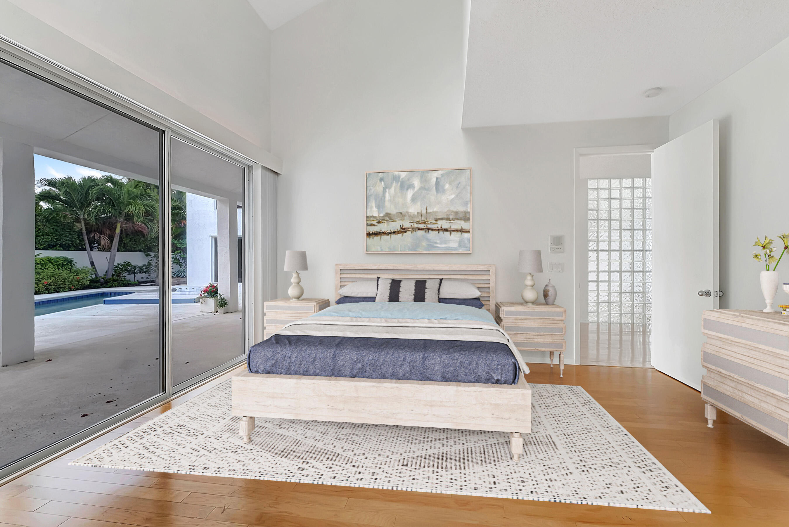 114 Olympus Circle Jupiter, FL 33477 - Photo 32 of 88 a spacious bedroom with a bed and wooden floor