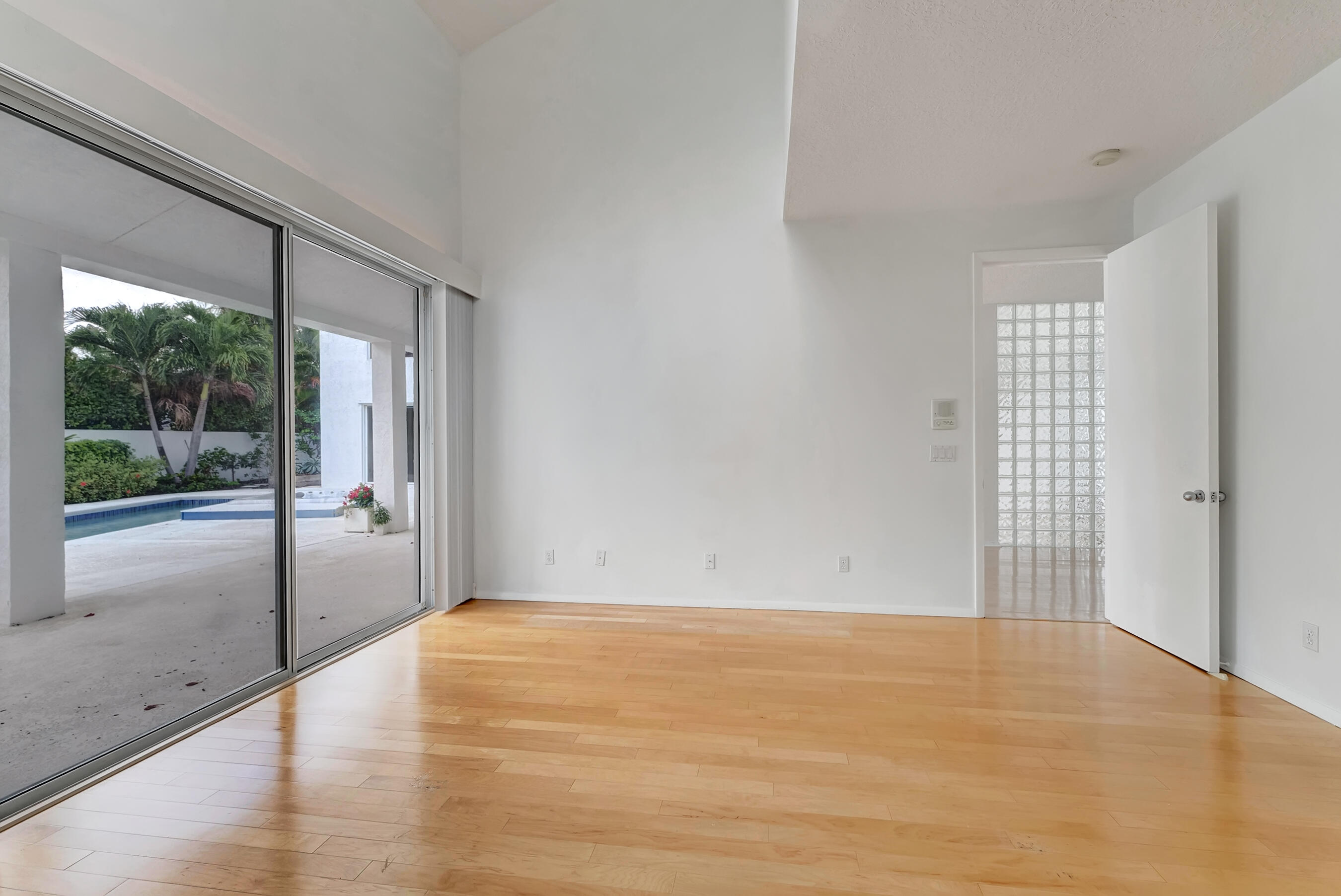 114 Olympus Circle Jupiter, FL 33477 - Photo 33 of 88 a view of an empty room with wooden floor and a window