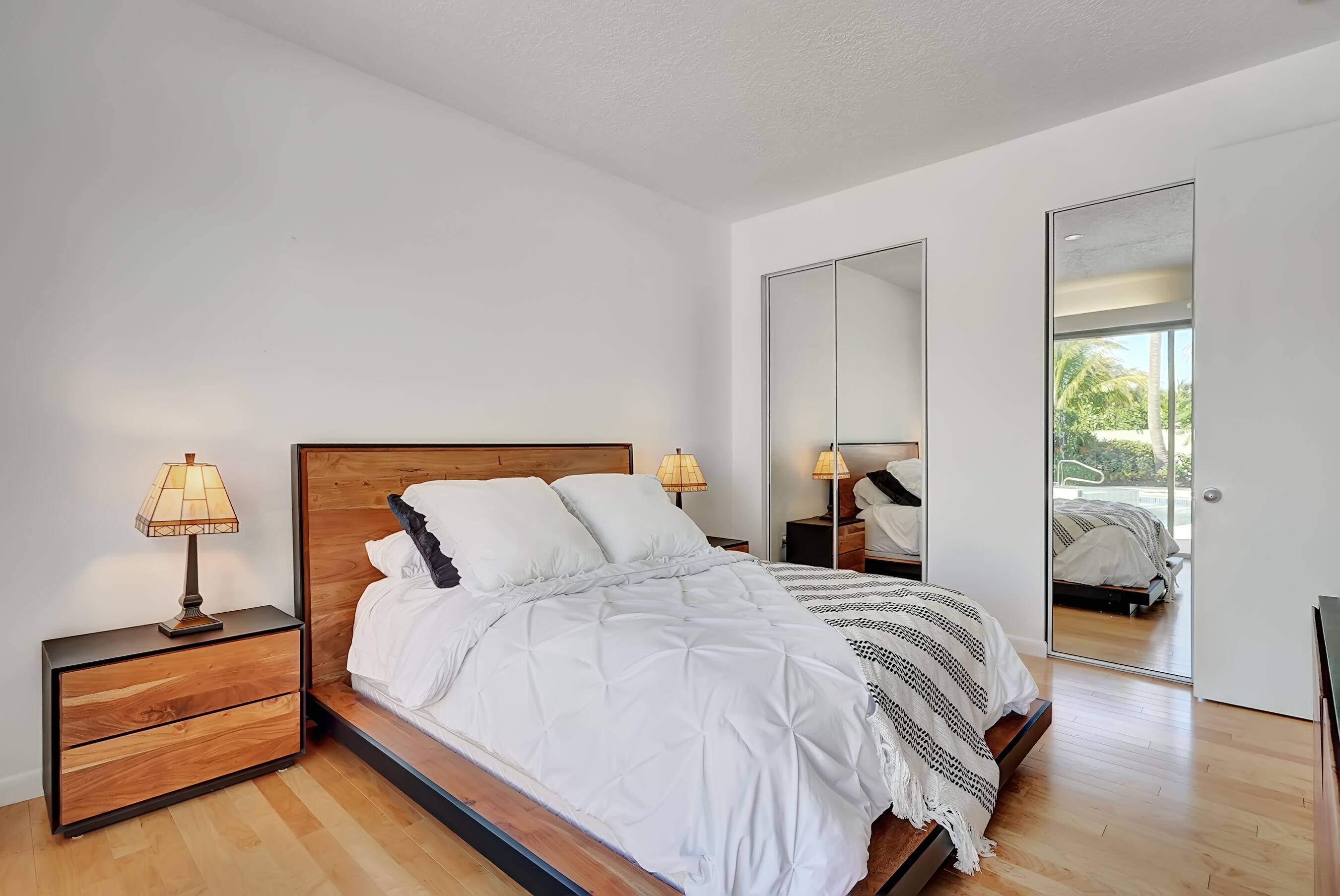 114 Olympus Circle Jupiter, FL 33477 - Photo 40 of 88 a bedroom with a bed and a lamp